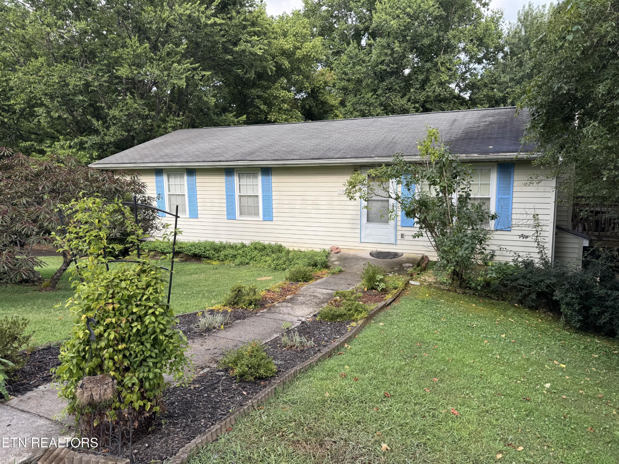 a front view of a house with garden