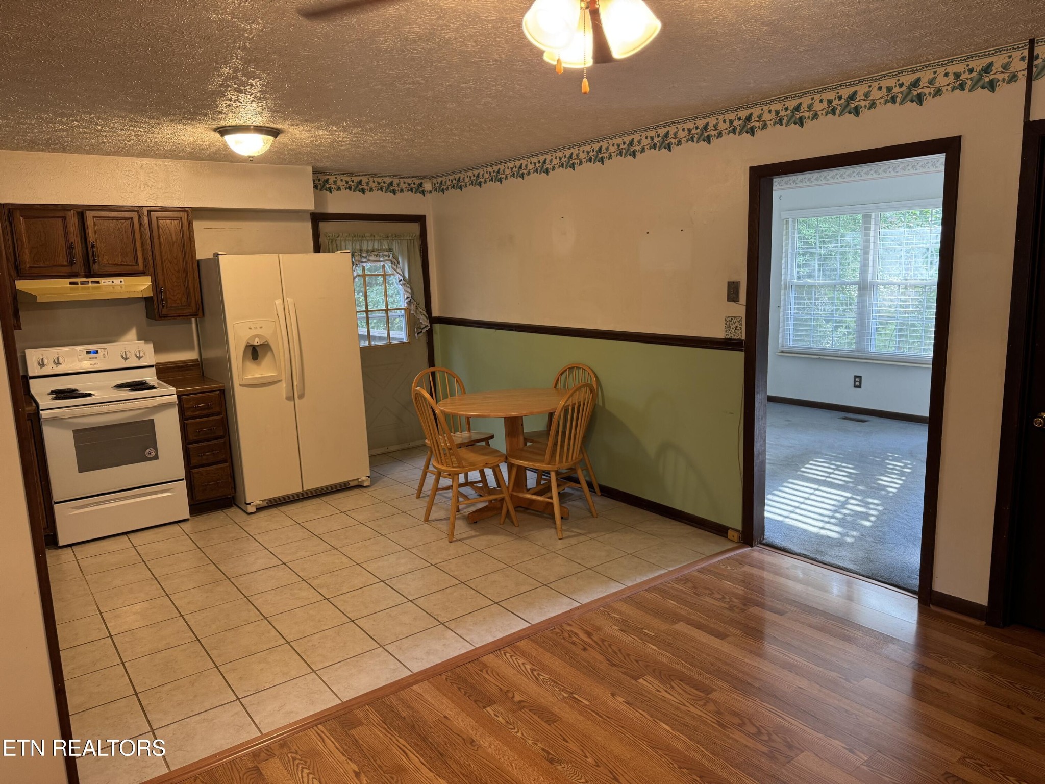372 Walnut Valley Road Clinton, TN 37716 - Photo 8 of 22 a kitchen with stainless steel appliances granite countertop a refrigerator and a stove top oven