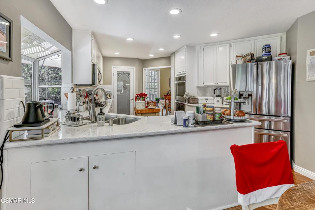 11816 Maple Crest Street Moorpark, CA 93021 - Photo 16 of 51 a kitchen with stainless steel appliances granite countertop a sink and cabinets