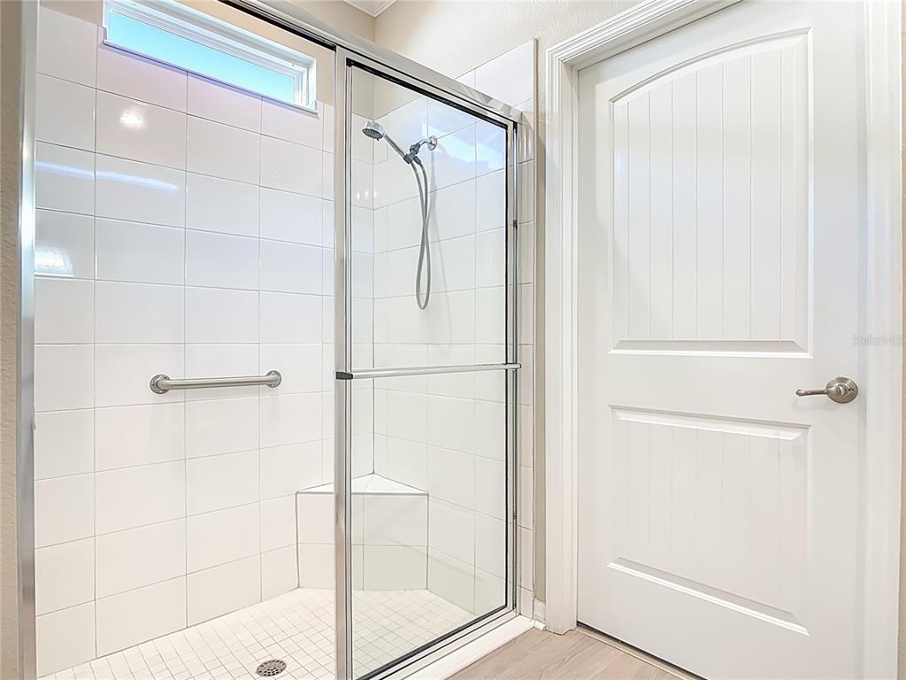 1632 Delphi Way New Smyrna Beach, FL 32168 - Photo 25 of 52 a bathroom with a glass shower door