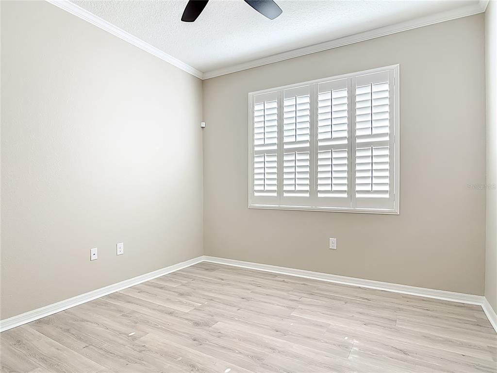 1632 Delphi Way New Smyrna Beach, FL 32168 - Photo 32 of 52 an empty room with wooden floor and windows