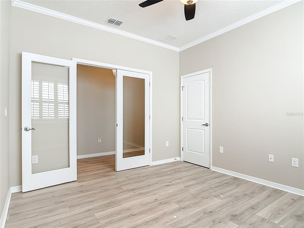 1632 Delphi Way New Smyrna Beach, FL 32168 - Photo 33 of 52 an empty room with wooden floor and windows
