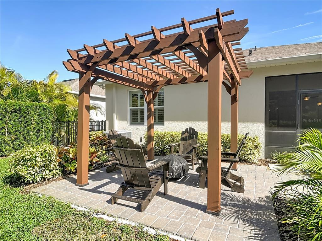 1632 Delphi Way New Smyrna Beach, FL 32168 - Photo 41 of 52 a view of a patio with table and chairs and potted plants