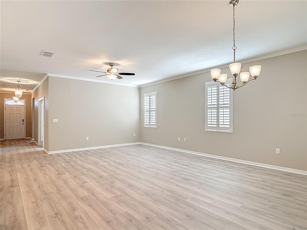 1632 Delphi Way New Smyrna Beach, FL 32168 - Photo 9 of 52 a view of a livingroom with a chandelier fan and wooden floor