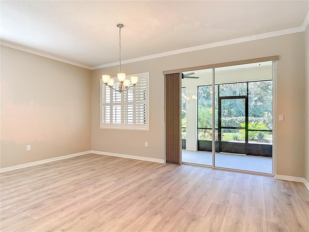1632 Delphi Way New Smyrna Beach, FL 32168 - Photo 10 of 52 a view of an empty room with wooden floor and a window