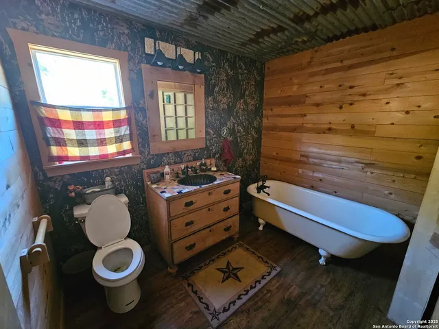 a bathroom with a toilet sink and mirror