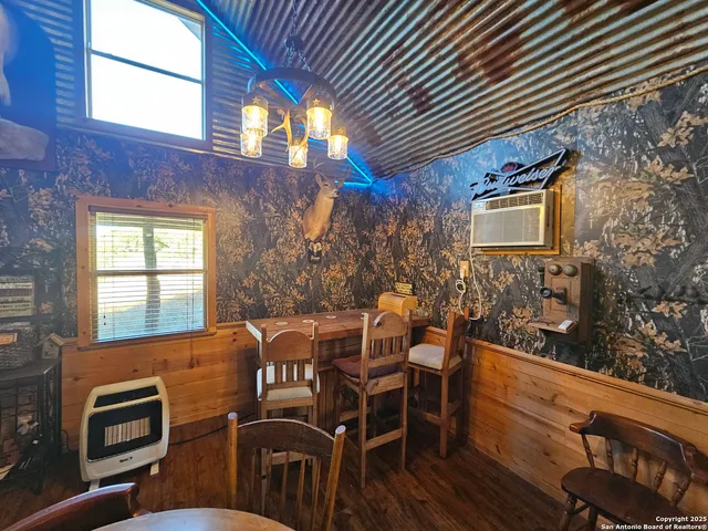 a view of a patio with table and chairs with wooden floor and fence