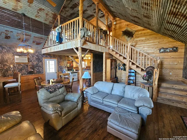 a roof deck with couches and potted plants