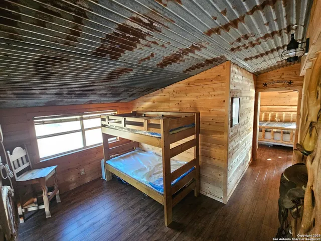 a view of a room with wooden floor and windows