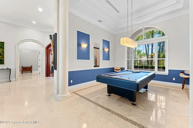 a room with furniture pool table and flat screen tv