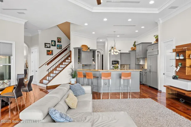 a kitchen that has a lot of cabinets in it and wooden floors