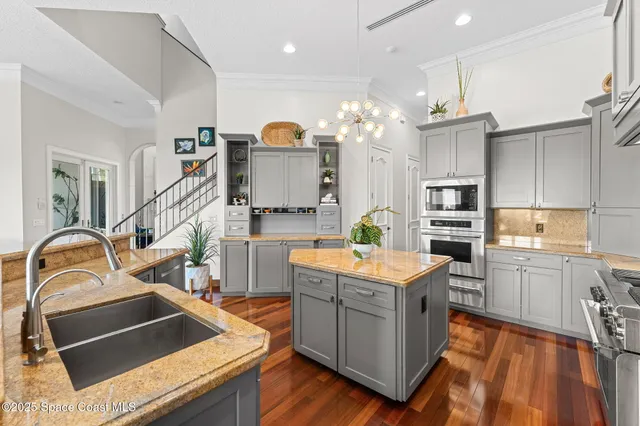a kitchen with counter top space a sink appliances and cabinets