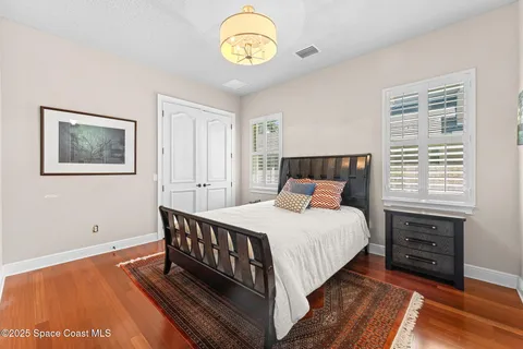 a bathroom with a granite countertop sink a toilet and a large mirror