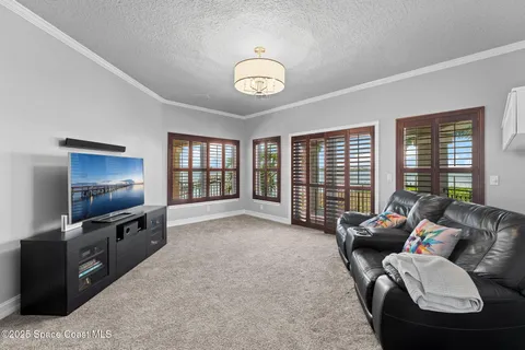 a living room with furniture and a floor to ceiling window