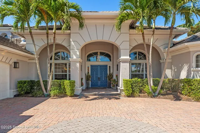 a living room with furniture fireplace and potted plants