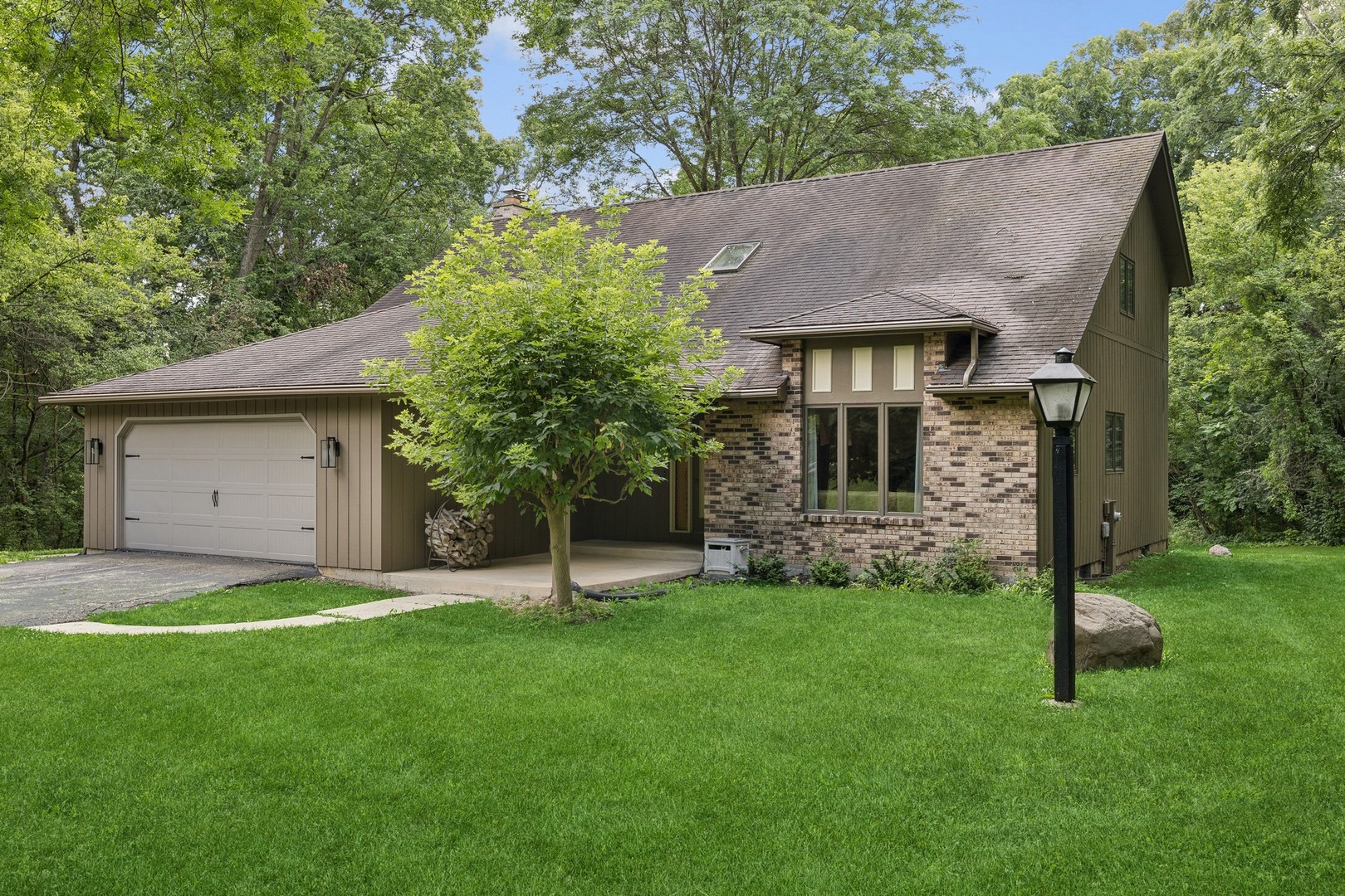 40W173 Oak Ridge Road St. Charles, IL 60175 - Photo 3 of 38 a view of a house with a yard and a large tree
