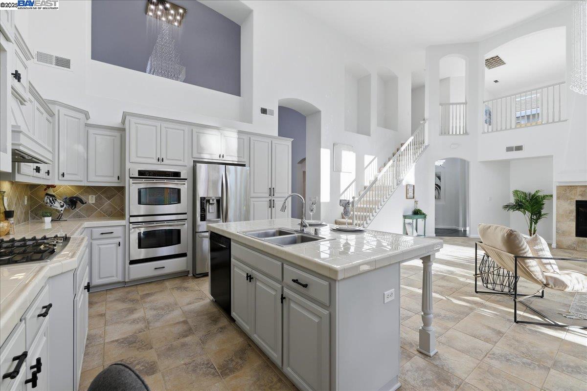 2455 Covelite Way Antioch, CA 94531 - Photo 14 of 60 a kitchen with stainless steel appliances granite countertop a stove oven and a refrigerator