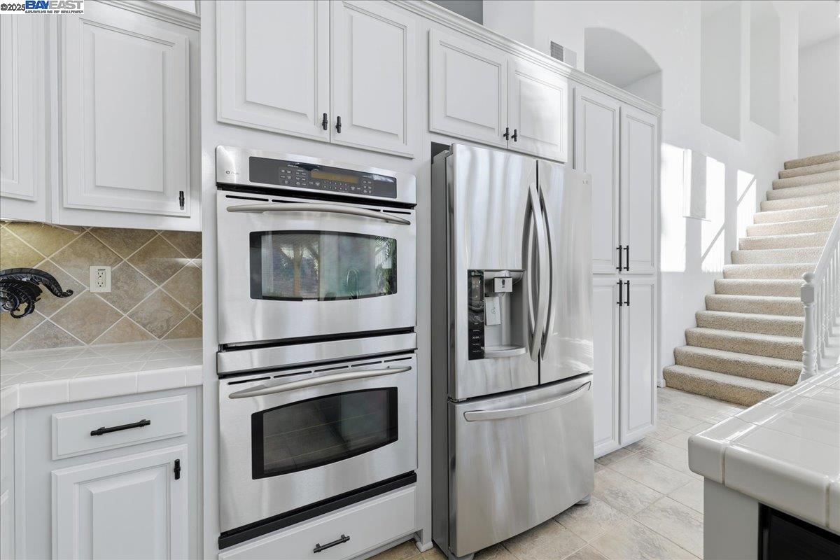 2455 Covelite Way Antioch, CA 94531 - Photo 20 of 60 a kitchen with stainless steel appliances white cabinets and white appliances