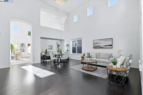 a living room with furniture a fireplace and a potted plant
