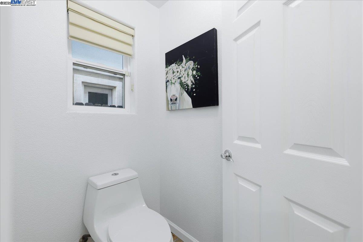 2455 Covelite Way Antioch, CA 94531 - Photo 36 of 60 a white toilet sitting next to a shower curtain
