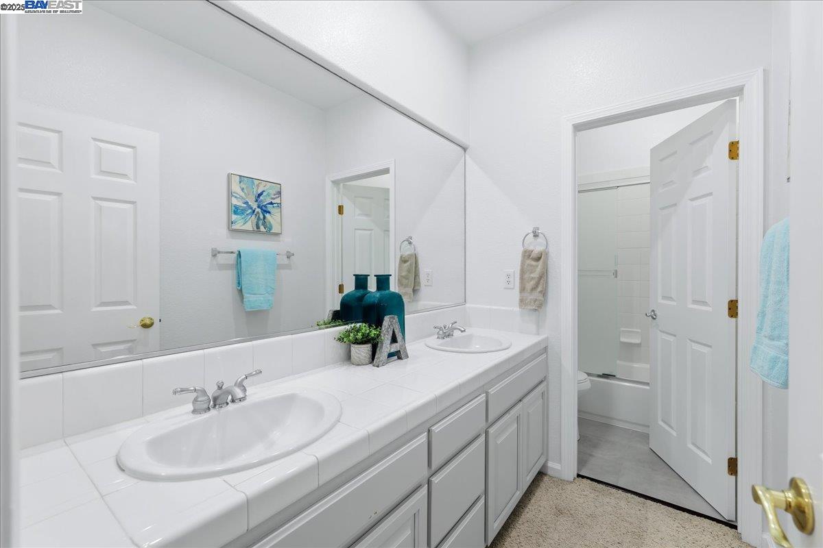 2455 Covelite Way Antioch, CA 94531 - Photo 49 of 60 a bathroom with a double vanity sink mirror and shower
