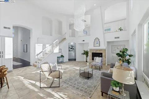 a living room with furniture a fireplace and a large window