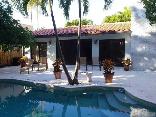 a view of a chairs and table in patio