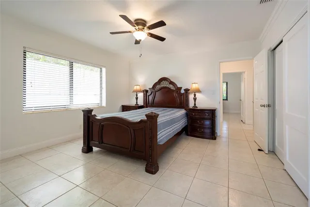 a bedroom with a bed and a table in it with window