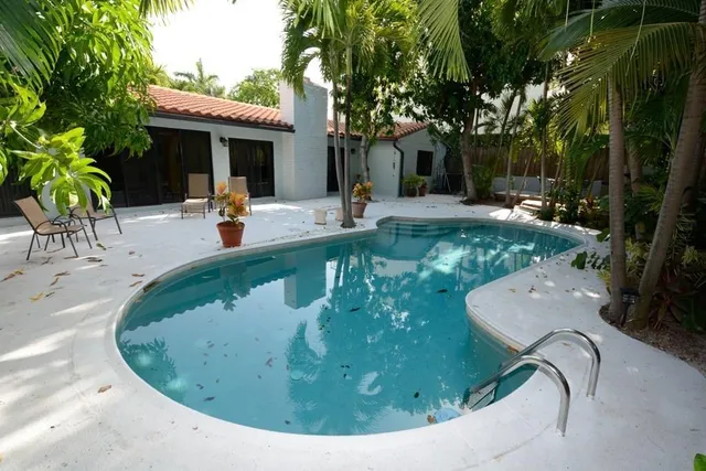 a view of a swimming pool with sitting area