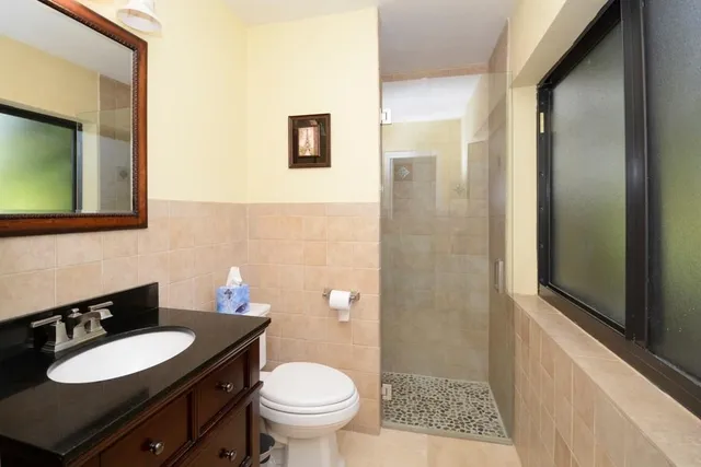 a bathroom with a sink toilet and shower