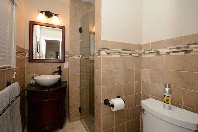 a bathroom with a toilet a sink and mirror