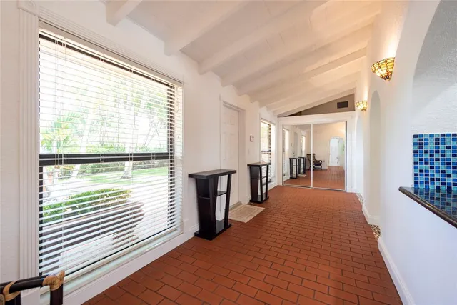a view of hallway with furniture and a large window