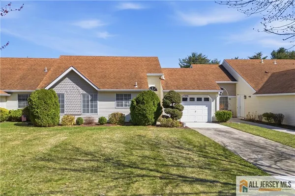 a view of a house with a big yard and potted plants