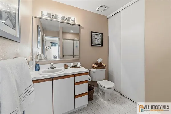 a bathroom with a toilet a sink and a mirror