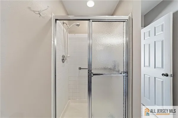 a bathroom with a glass shower door