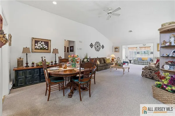 a view of a dining room with furniture and a chandelier