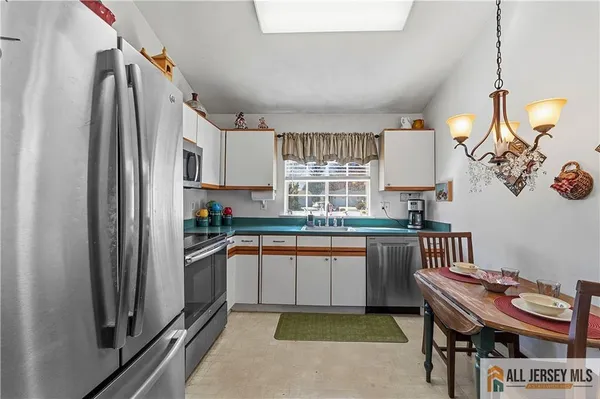 a kitchen with stainless steel appliances granite countertop a sink and a refrigerator