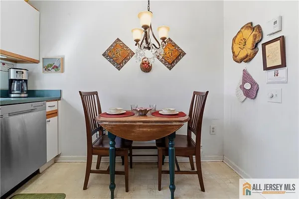 a view of a dining room with a table and chairs