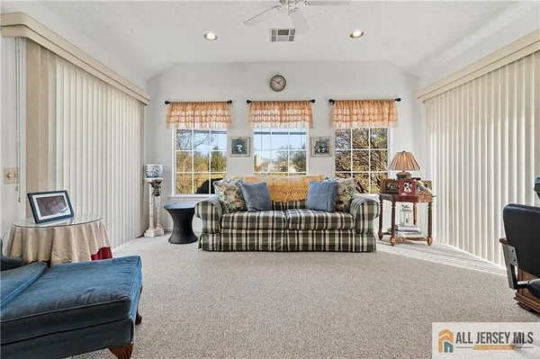 a living room with furniture a window and a flat screen tv
