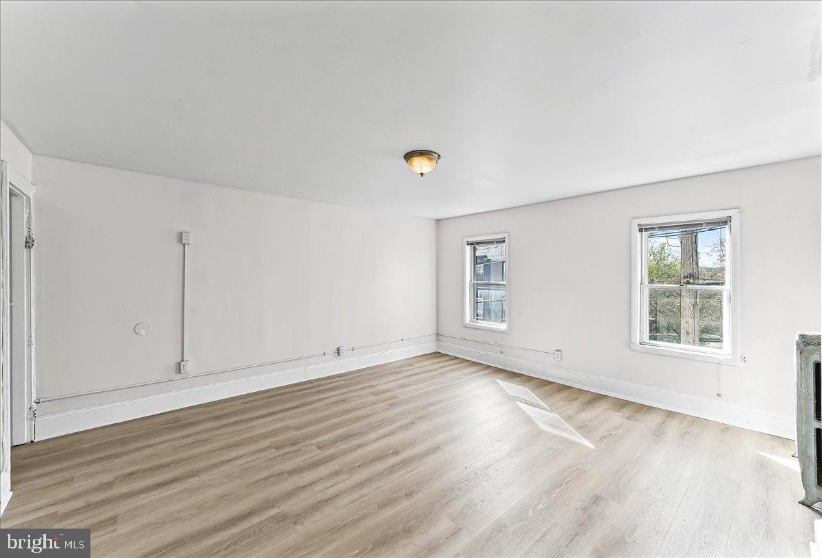3654 Calumet Street Philadelphia, PA 19129 - Photo 24 of 33 an empty room with wooden floor and windows