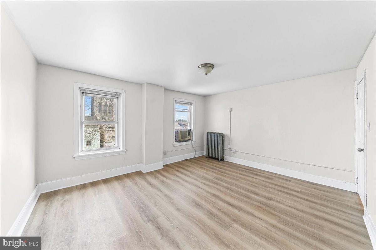 3654 Calumet Street Philadelphia, PA 19129 - Photo 25 of 33 an empty room with wooden floor and windows