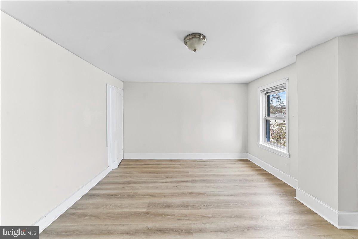 3654 Calumet Street Philadelphia, PA 19129 - Photo 26 of 33 a view of an empty room with wooden floor and a window