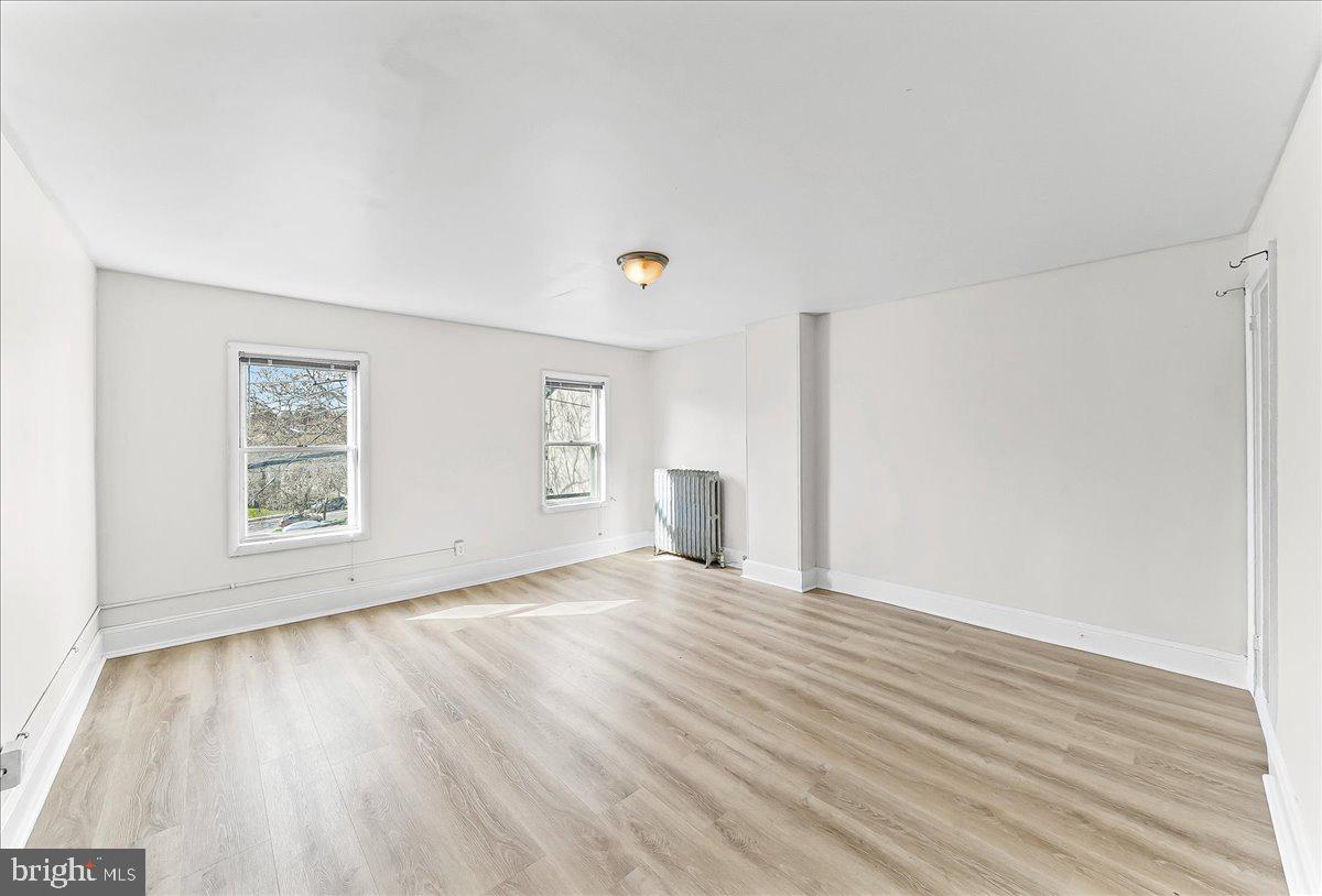 3654 Calumet Street Philadelphia, PA 19129 - Photo 27 of 33 a view of an empty room with wooden floor and a window