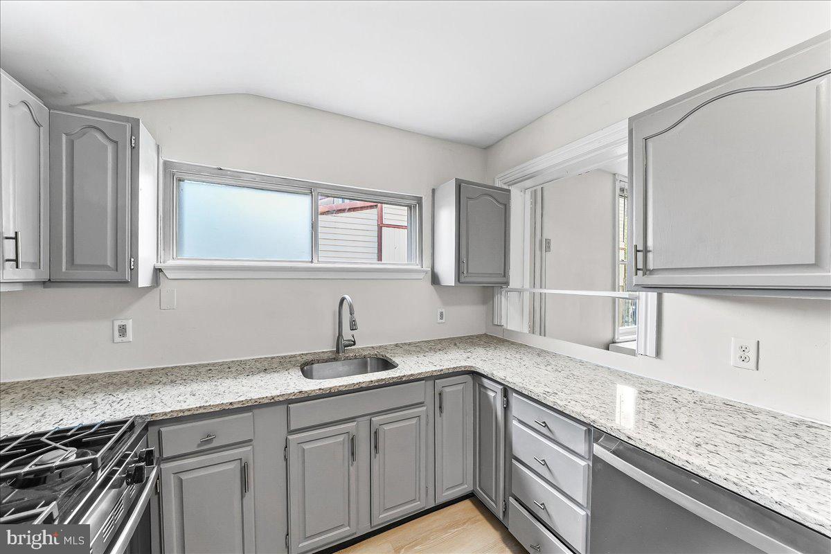 3654 Calumet Street Philadelphia, PA 19129 - Photo 10 of 33 a kitchen with granite countertop a sink and cabinets