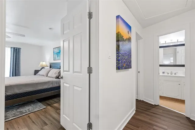 a bedroom with a bed table and a window