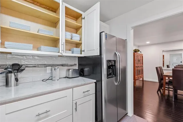 a kitchen with stainless steel appliances granite countertop a sink dishwasher and cabinets with wooden floor
