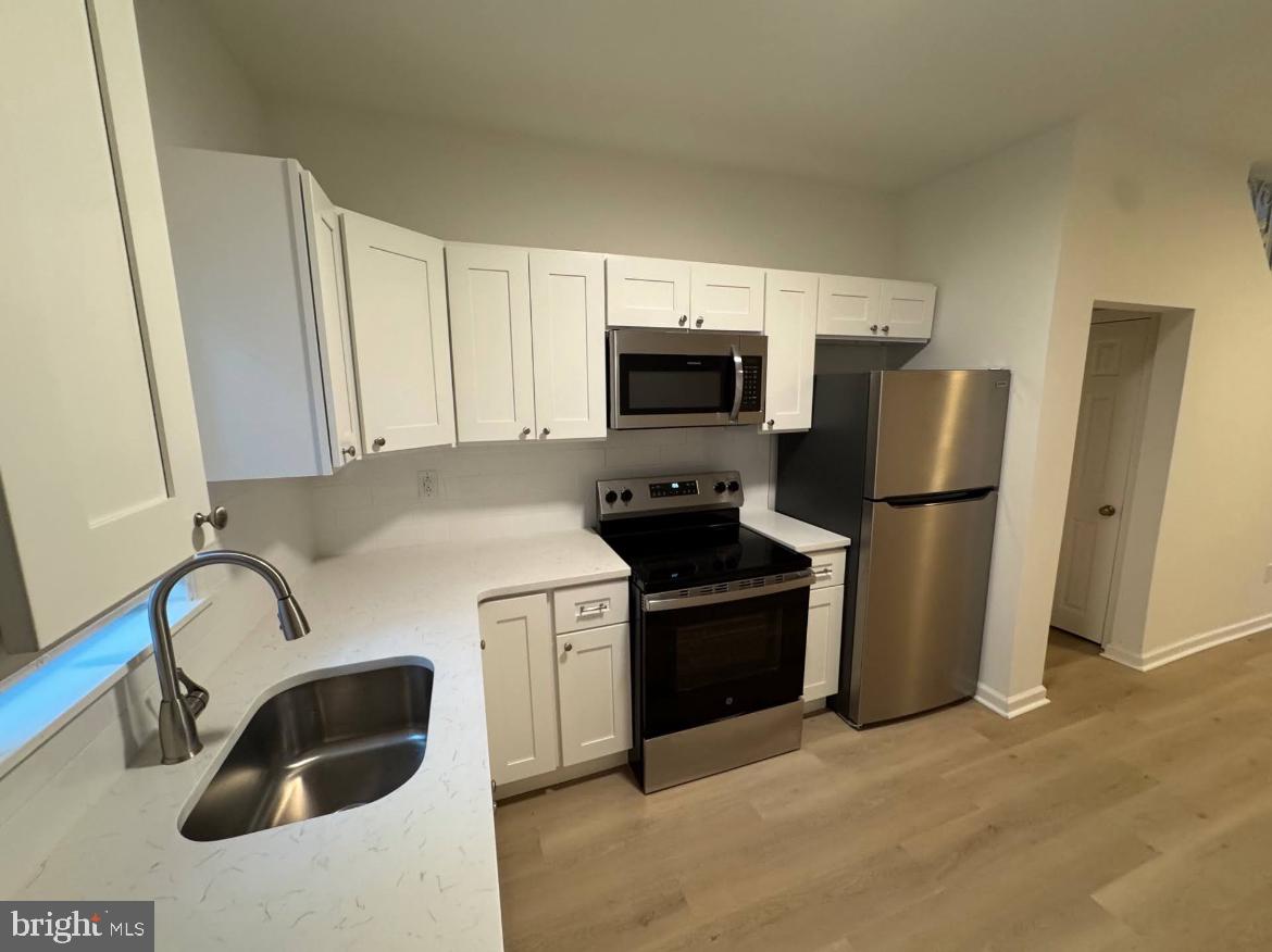 3252 Hope Street Philadelphia, PA 19140 - Photo 13 of 19 a kitchen with stainless steel appliances a refrigerator stove and sink