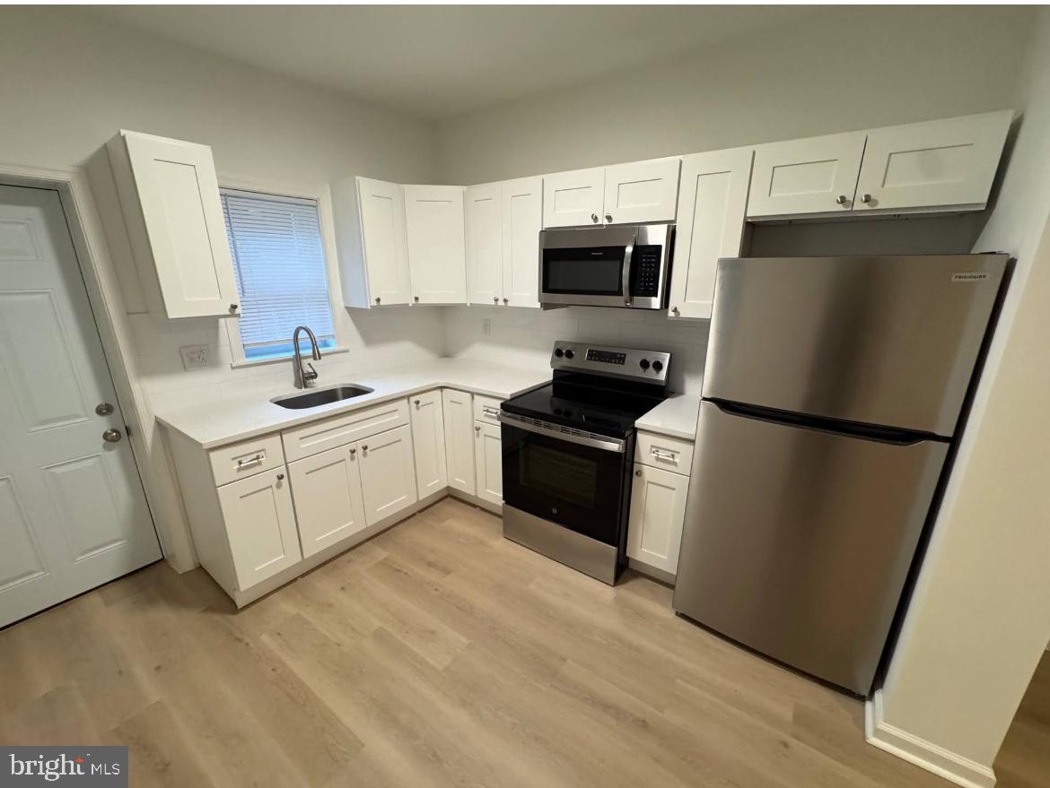 3252 Hope Street Philadelphia, PA 19140 - Photo 14 of 19 a kitchen with a sink appliances and cabinets