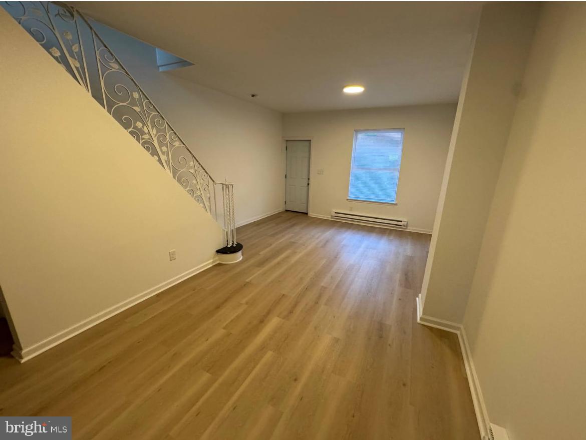 3252 Hope Street Philadelphia, PA 19140 - Photo 15 of 19 a view of an empty room with wooden floor