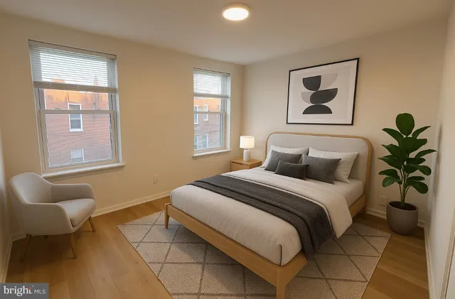 a bedroom with a bed and painting on the wall